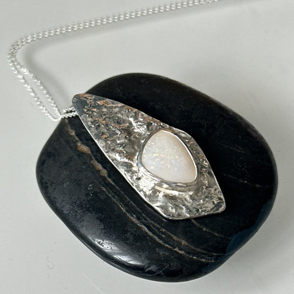Coober Pedy opal silver necklace showcasing a unique textured pendant with a milky white opal set in sterling silver.