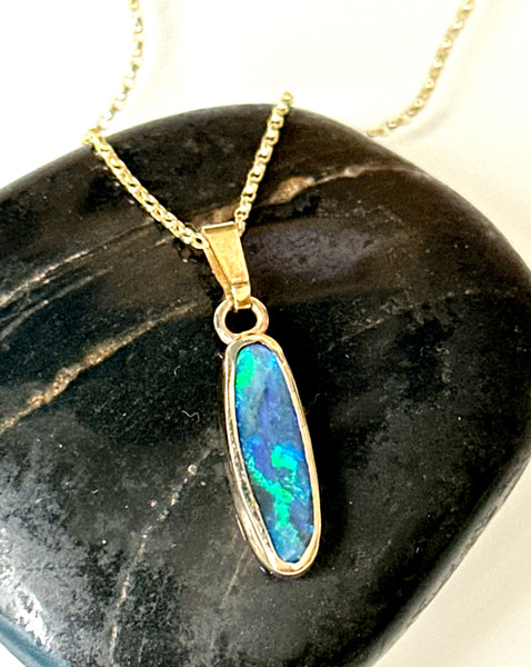 9 Carat Gold Solid Black Opal Pendant Necklace featuring deep blue and neon flashes on a gold chain