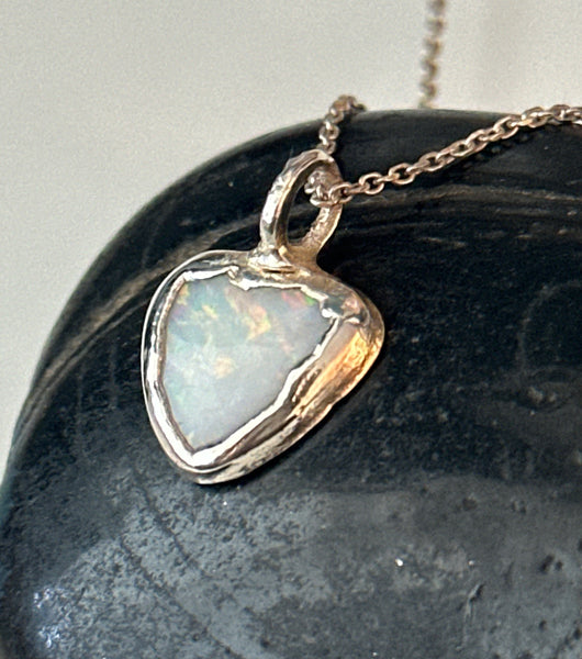 Coober Pedy opal silver pendant necklace featuring a heart-shaped opal with neon colors on a silver chain.