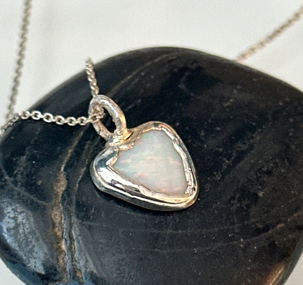 Coober Pedy opal silver pendant necklace showcasing a triangular heart-shaped opal set in textured silver.